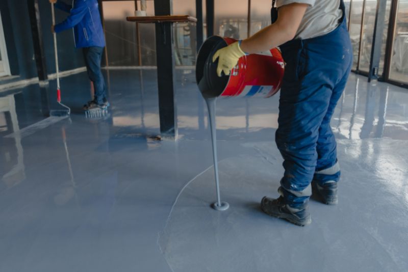 two men installing epoxy floor