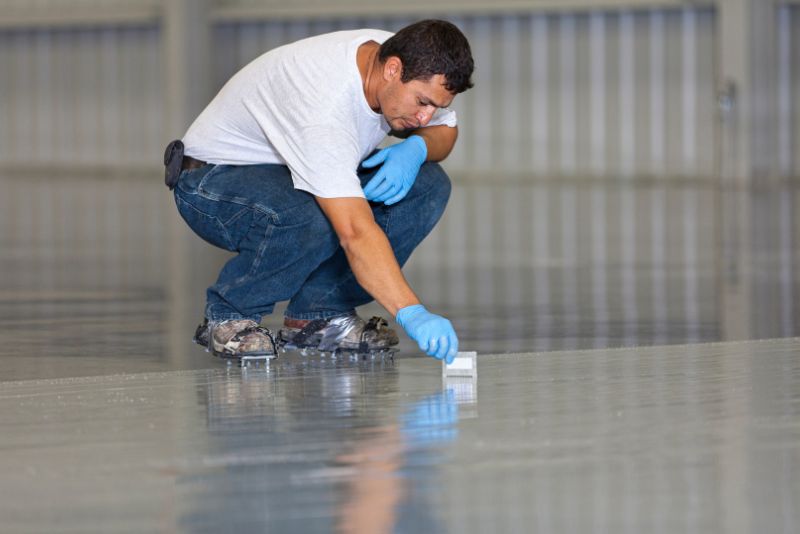 man inspecting expoxy floor installation